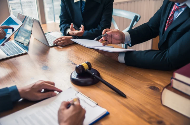Couple reviewing divorce paperwork with an attorney across a desk